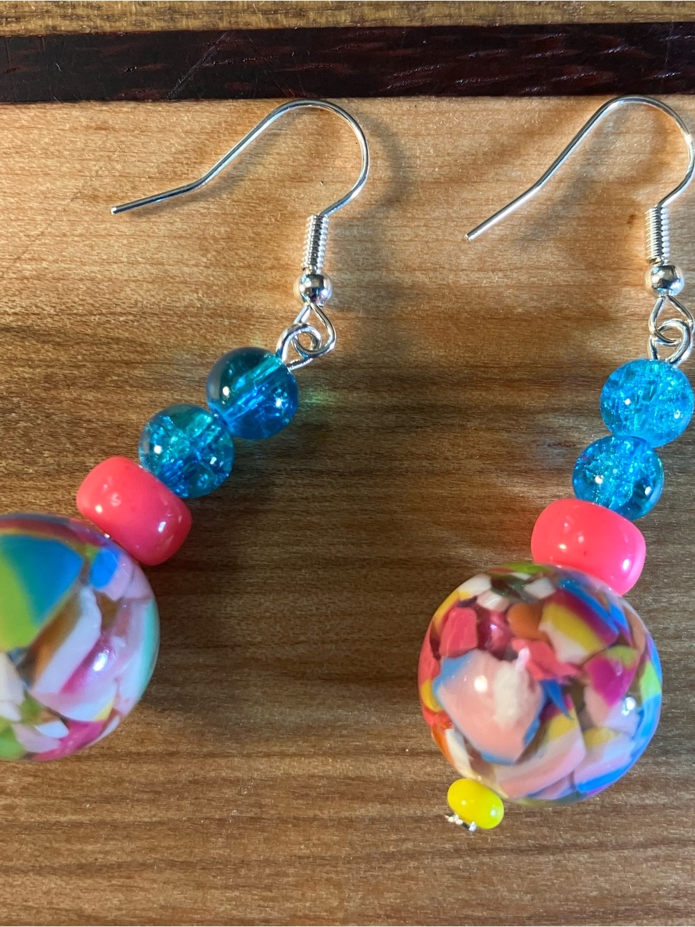 Colorful earrings made with a mix of crackled glass and acrylic resin